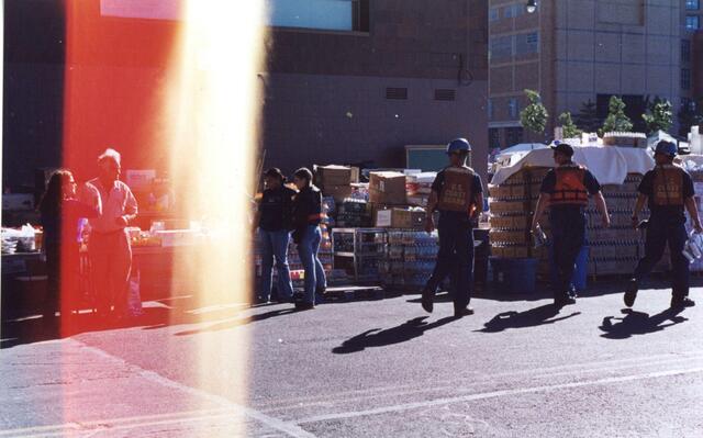 First responders gather at BMCC in the aftermath of 9/11. A flare of light runs from top to bottom of the image.